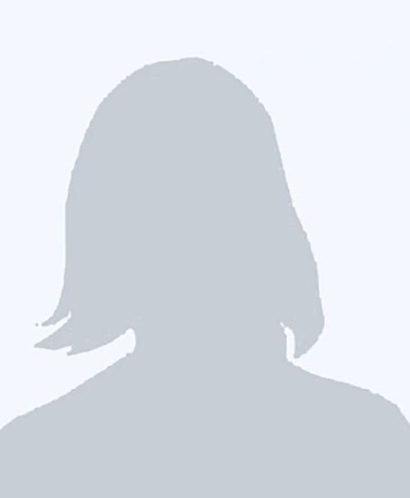 A gray silhouette of a person with shoulder-length hair against a light gray background, commonly used as a placeholder for a profile photo.